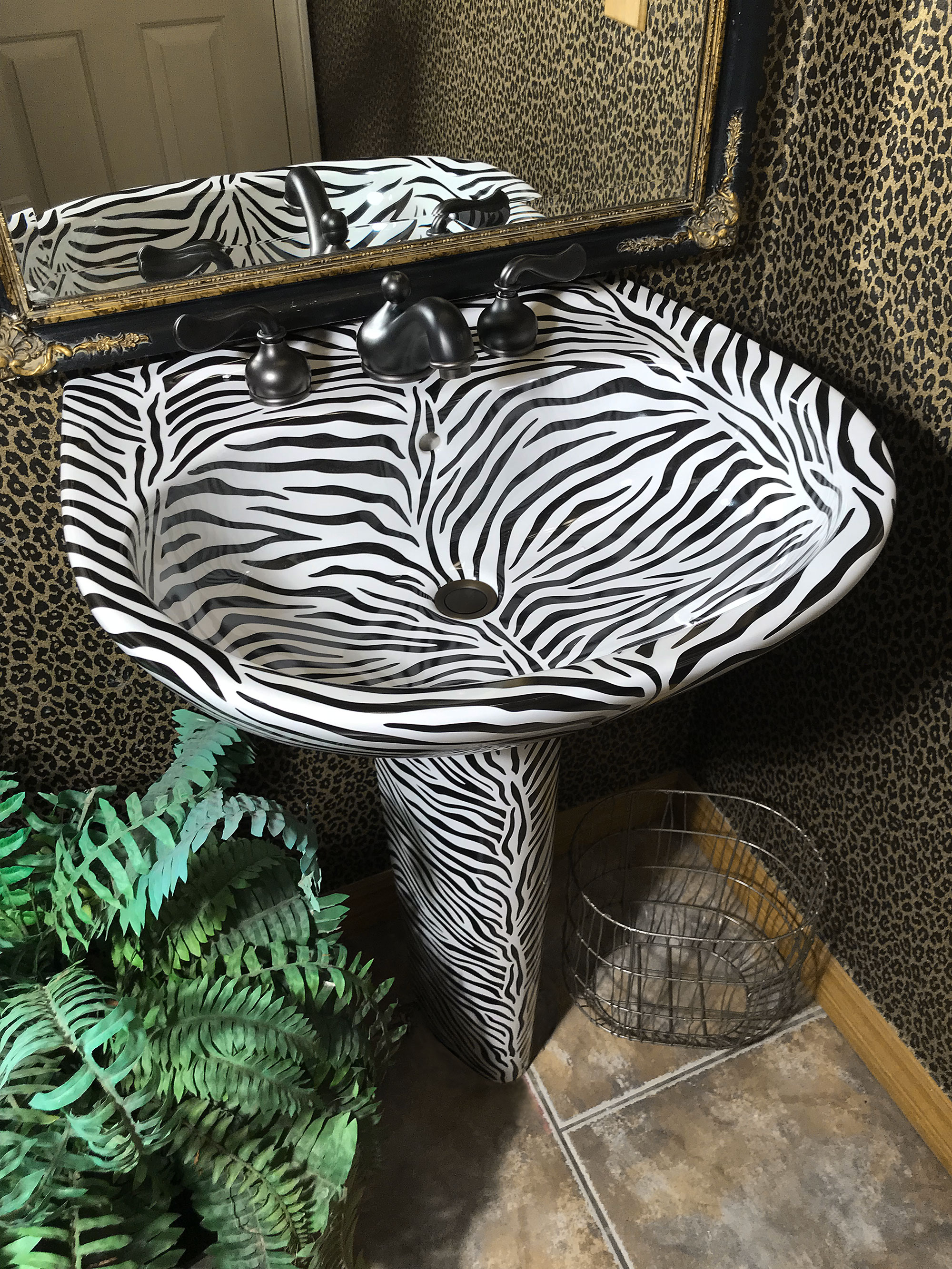 zebra pedestal sink in jungle bathroom