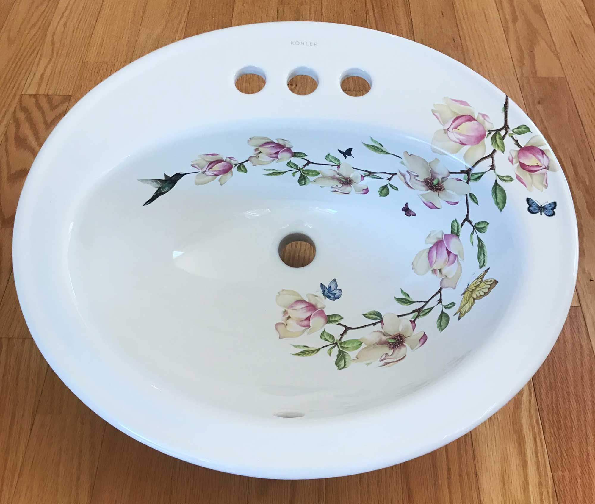 Magnolia Painted sink with several butterflies and a hummingbird